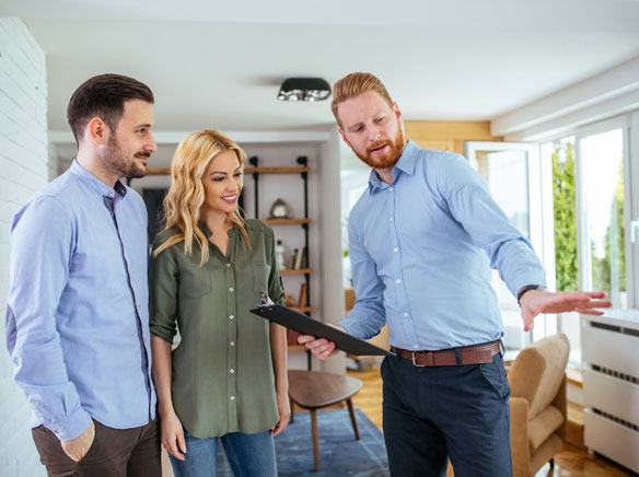 A Ringdahl pest control professional reviewing a treatment plan with a couple inside their home