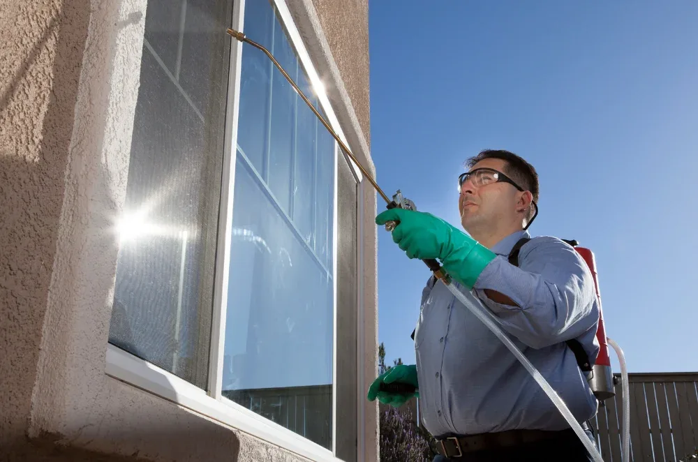 Technician providing residential pest control service at a South Florida home